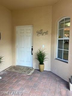 7832 Meridan Court Naples, FL 34104 - Photo 4 of 18 a view of an empty room with a window and potted plants