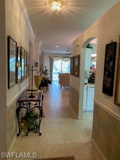 7832 Meridan Court Naples, FL 34104 - Photo 5 of 18 a living room with furniture and a flat screen tv