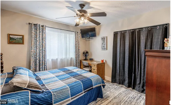 a bedroom with furniture and a chandelier