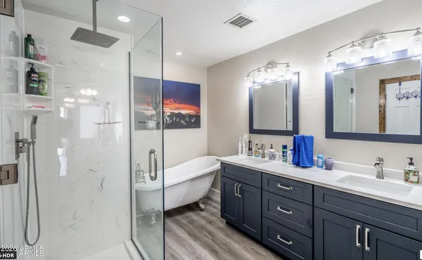 a bathroom with a bathtub and a painting