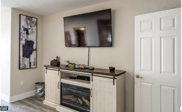 a living room with furniture large window and a fireplace
