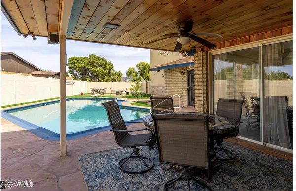 swimming pool view with a seating space