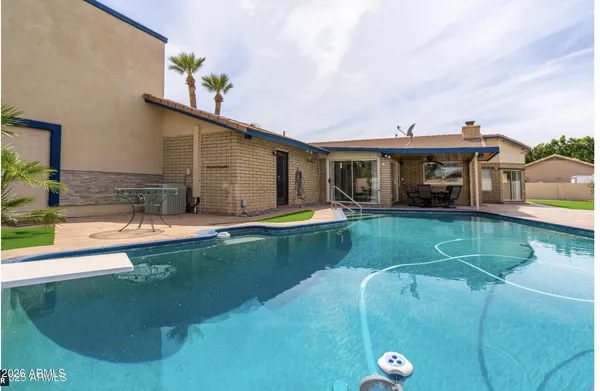 a view of swimming pool with seating area