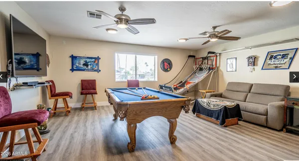 a view of a workspace with furniture and a window