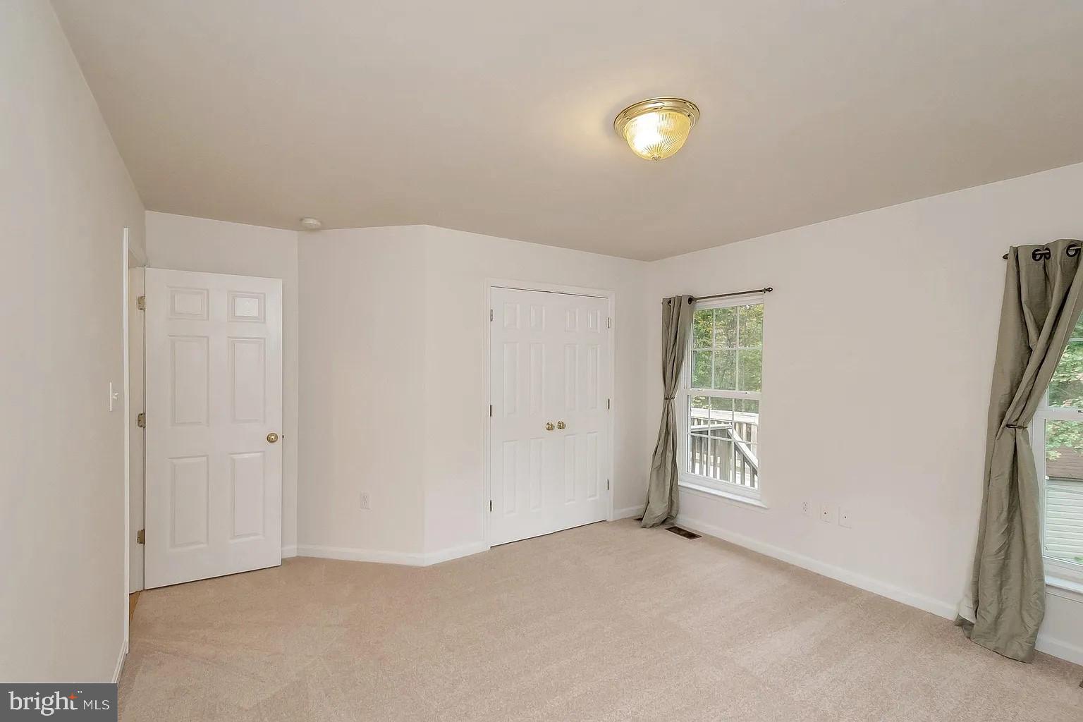 309 Liberty Boulevard Locust Grove, VA 22508 - Photo 12 of 42 an empty room with windows and closet