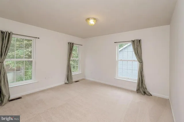 an empty room with windows and entrance