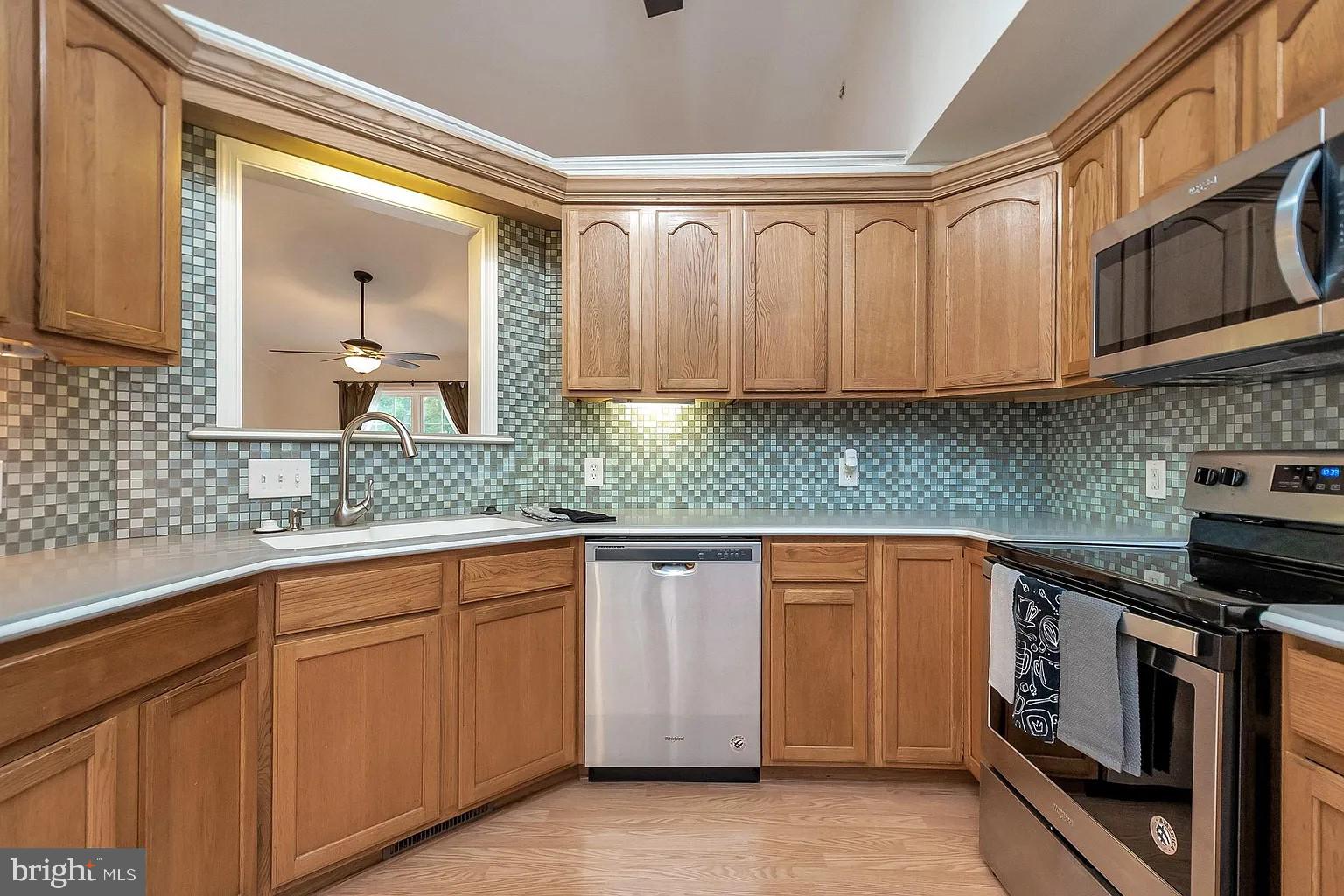 309 Liberty Boulevard Locust Grove, VA 22508 - Photo 2 of 42 a kitchen with granite countertop cabinets stainless steel appliances and a sink