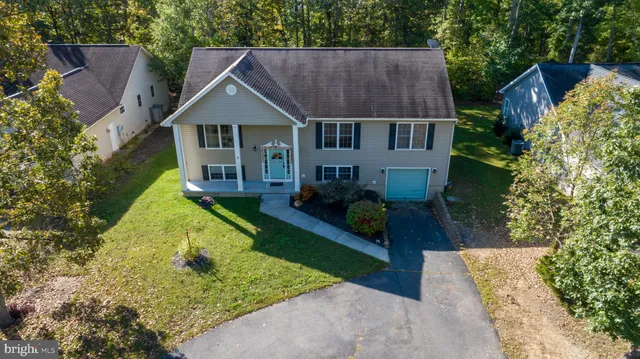 a aerial view of a house with a yard table and chairs