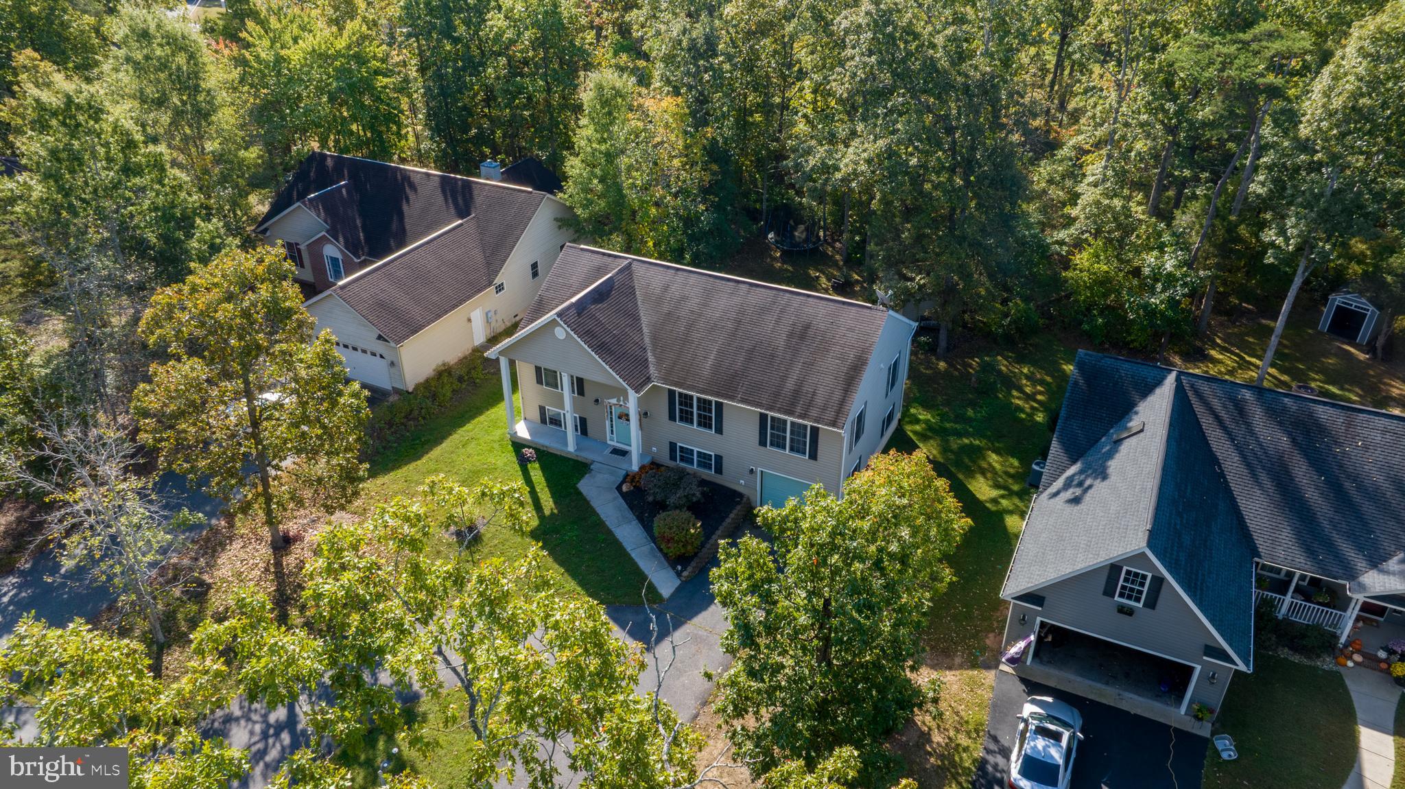 309 Liberty Boulevard Locust Grove, VA 22508 - Photo 33 of 42 an aerial view of a house with garden space and trees all around