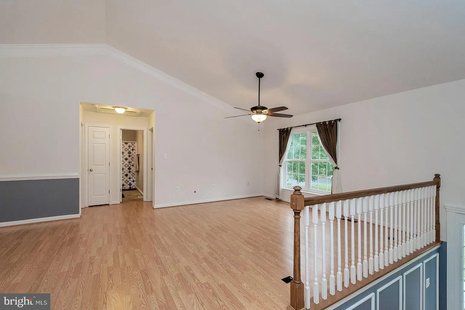 309 Liberty Boulevard Locust Grove, VA 22508 - Photo 8 of 42 an empty room with wooden floor fan and windows
