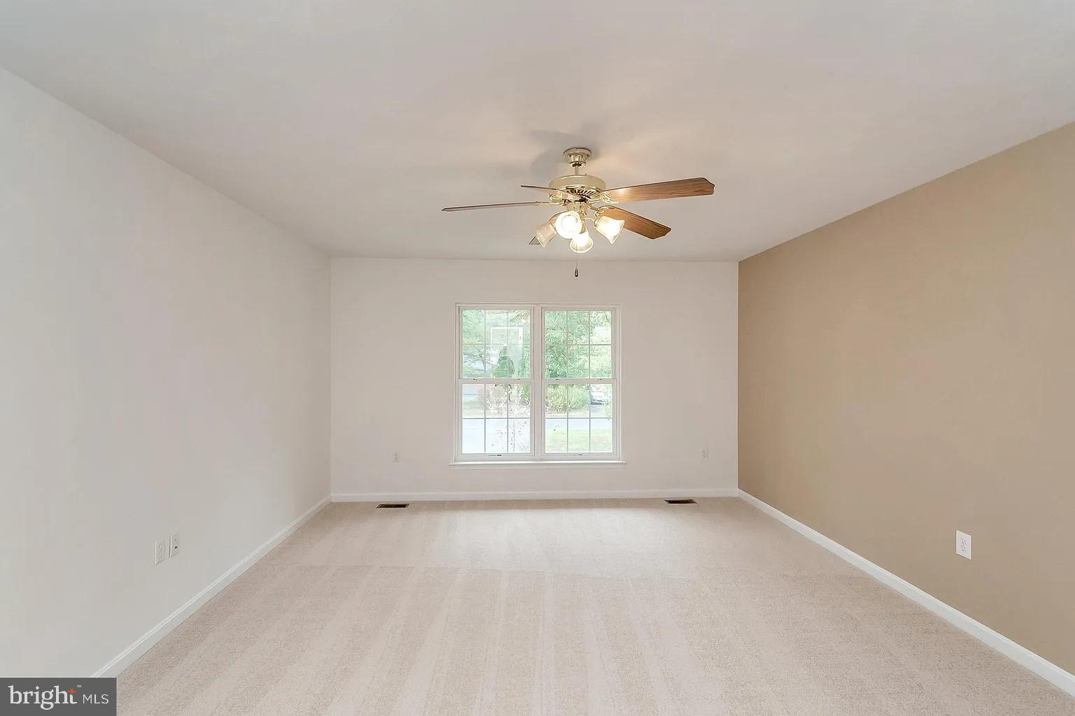 309 Liberty Boulevard Locust Grove, VA 22508 - Photo 9 of 42 an empty room with a window and a fan