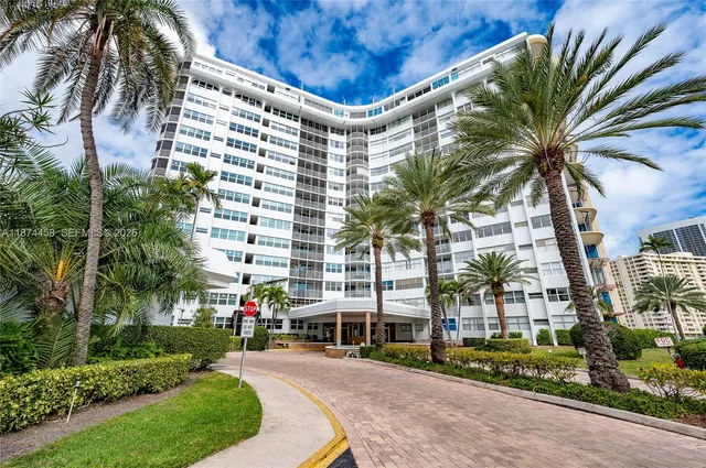 a view of a palm trees in front of a building