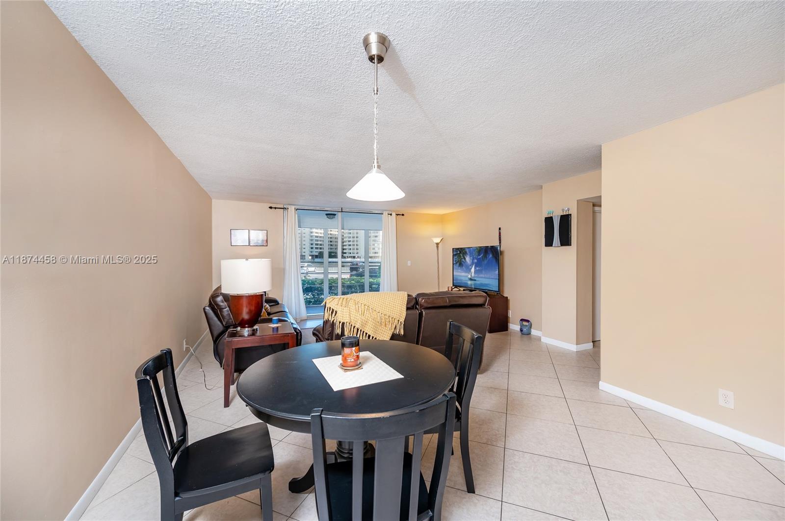 100 Golden Isles Drive, Unit 104 Hallandale Beach, FL 33009 - Photo 11 of 28 a view of a dining room with furniture