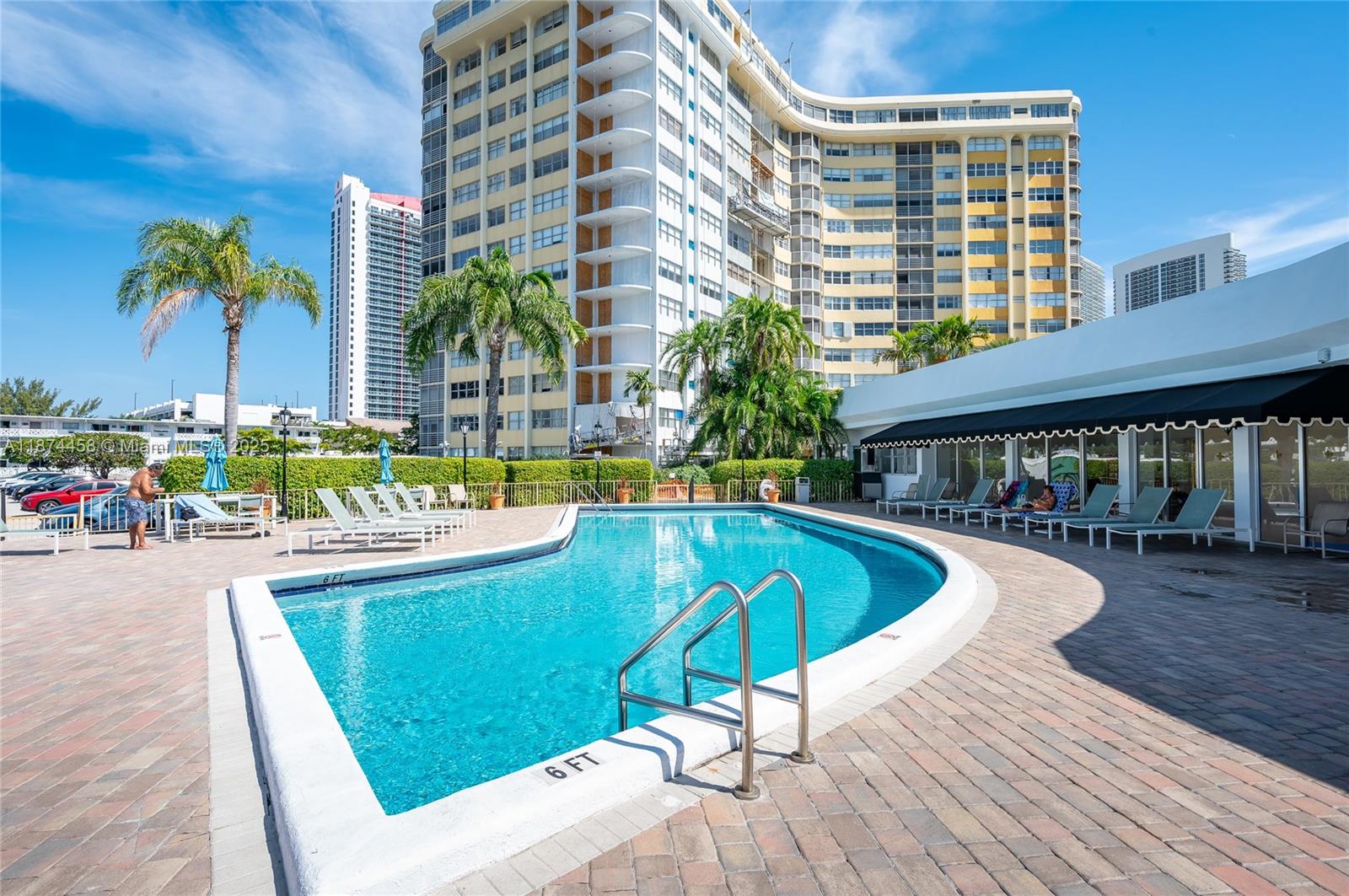 100 Golden Isles Drive, Unit 104 Hallandale Beach, FL 33009 - Photo 2 of 28 a swimming pool with outdoor seating and yard