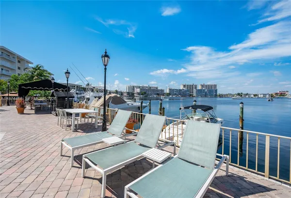 a view of a roof deck with couches and wooden floor