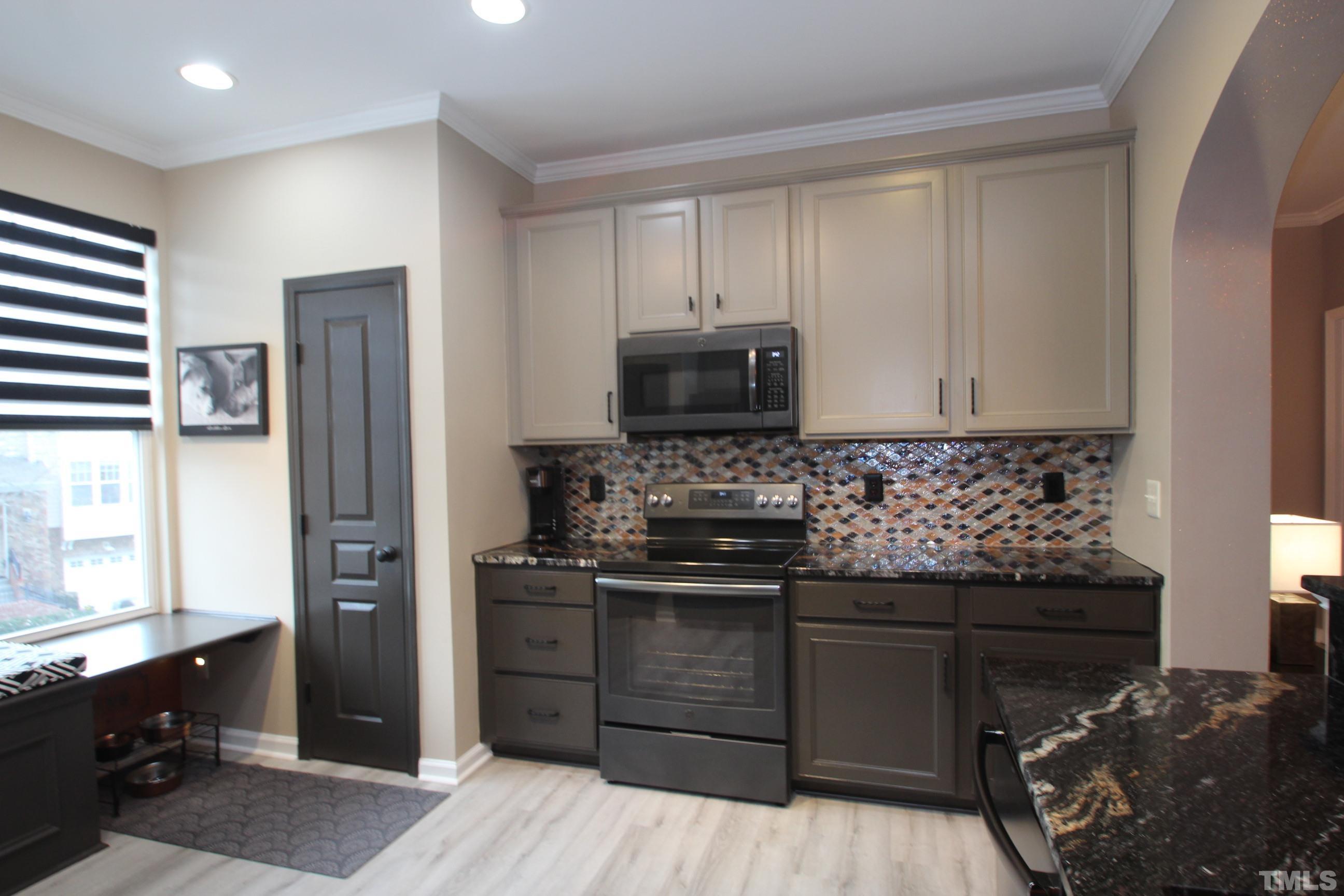 5804 Cameo Glass Way Raleigh, NC 27612 - Photo 2 of 25 a kitchen with stainless steel appliances granite countertop a refrigerator and a stove top oven