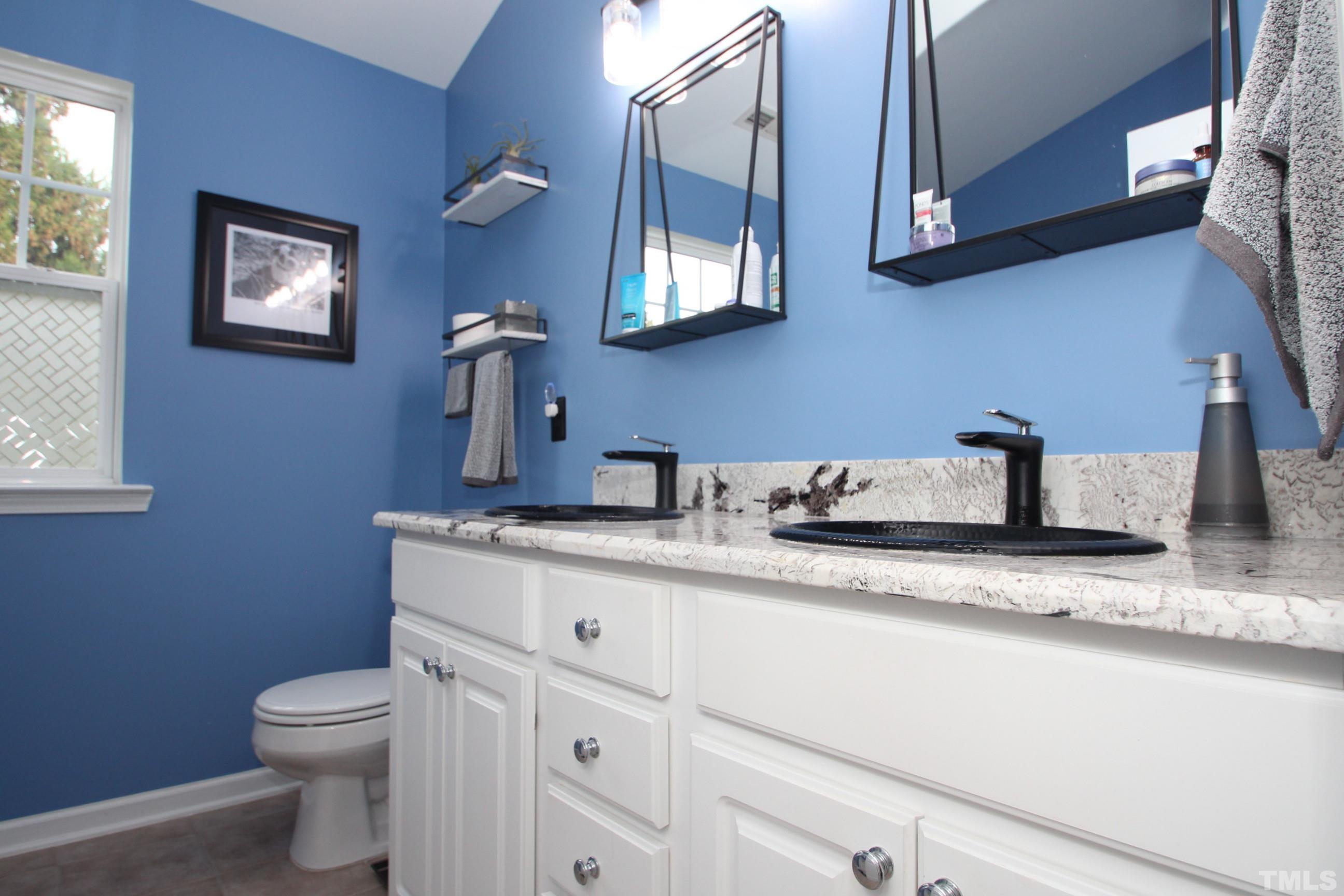5804 Cameo Glass Way Raleigh, NC 27612 - Photo 11 of 25 a bathroom with a granite countertop toilet sink and mirror