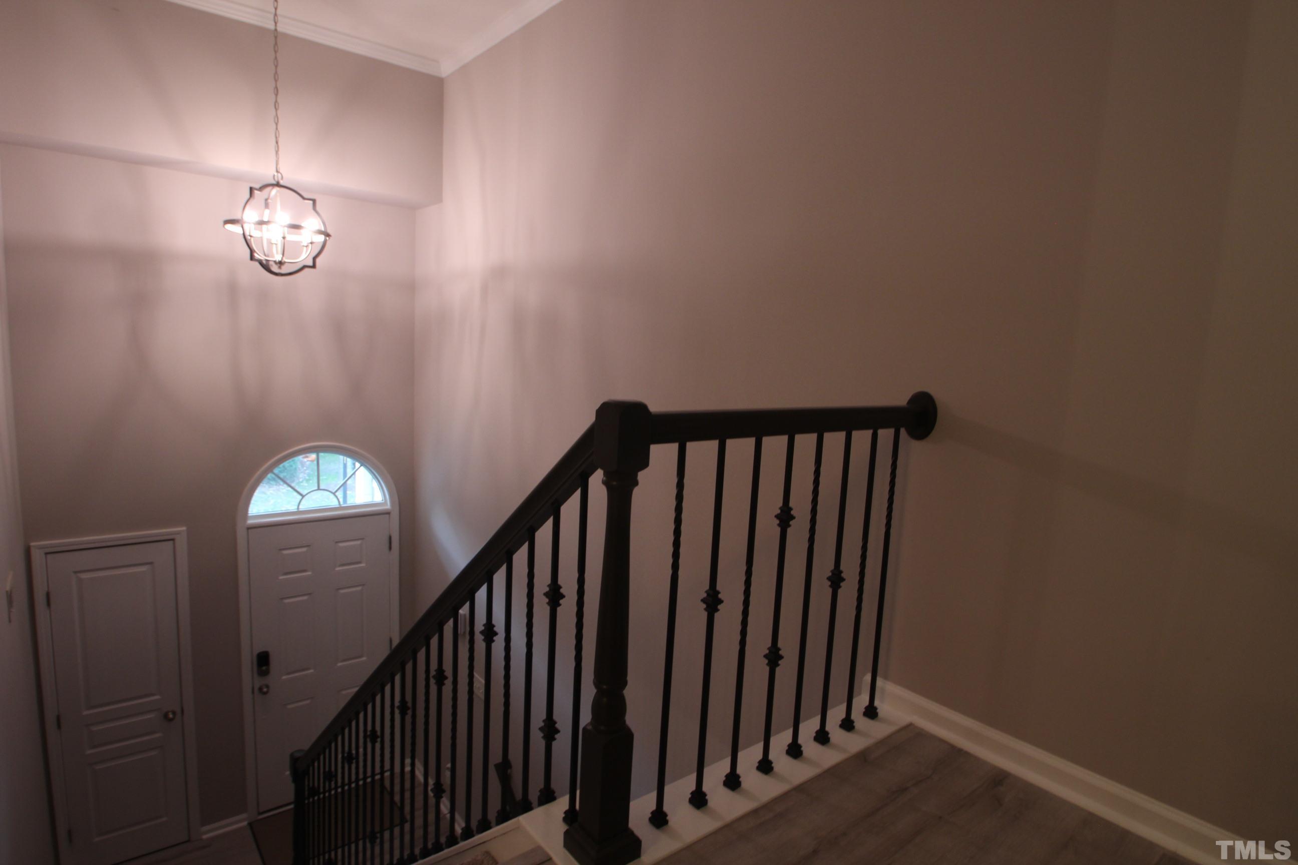 5804 Cameo Glass Way Raleigh, NC 27612 - Photo 16 of 25 a view of staircase with railing and a chandelier
