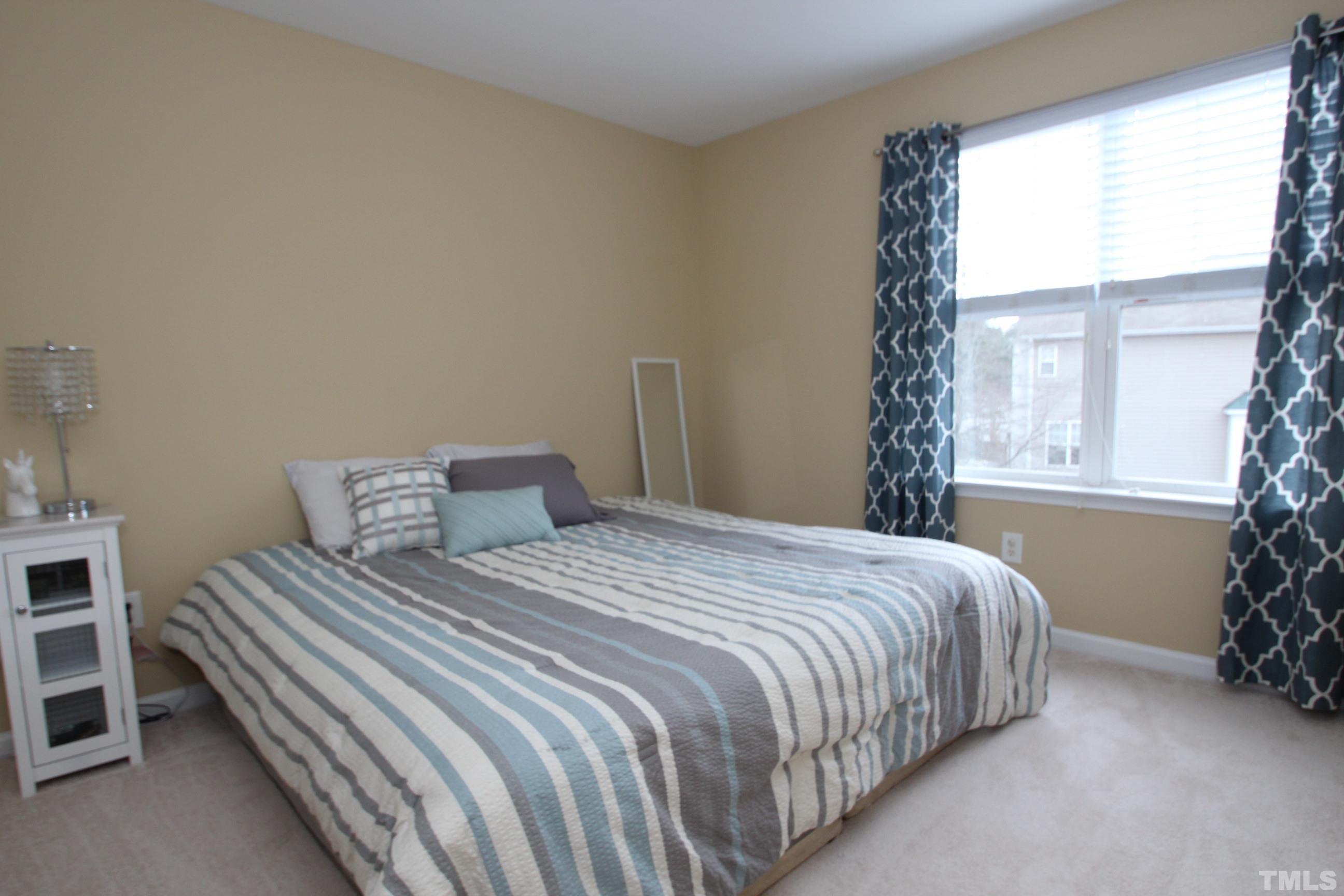 5804 Cameo Glass Way Raleigh, NC 27612 - Photo 19 of 25 a bedroom with a bed and a window