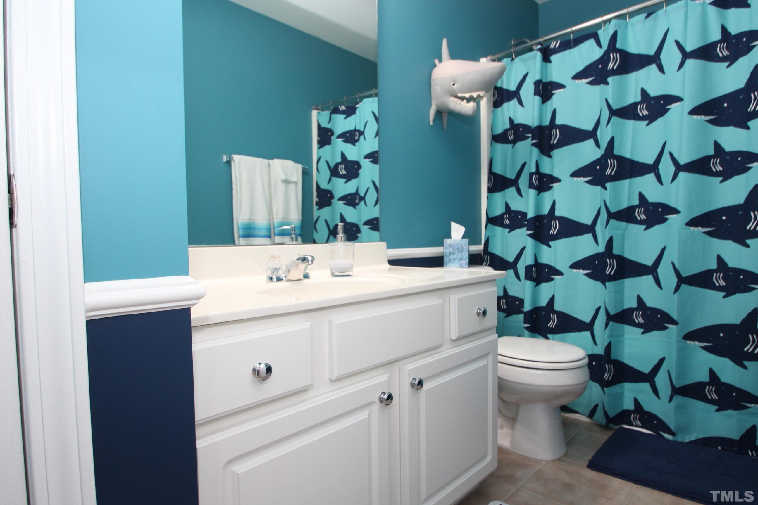 5804 Cameo Glass Way Raleigh, NC 27612 - Photo 20 of 25 a bathroom with a sink toilet and shower