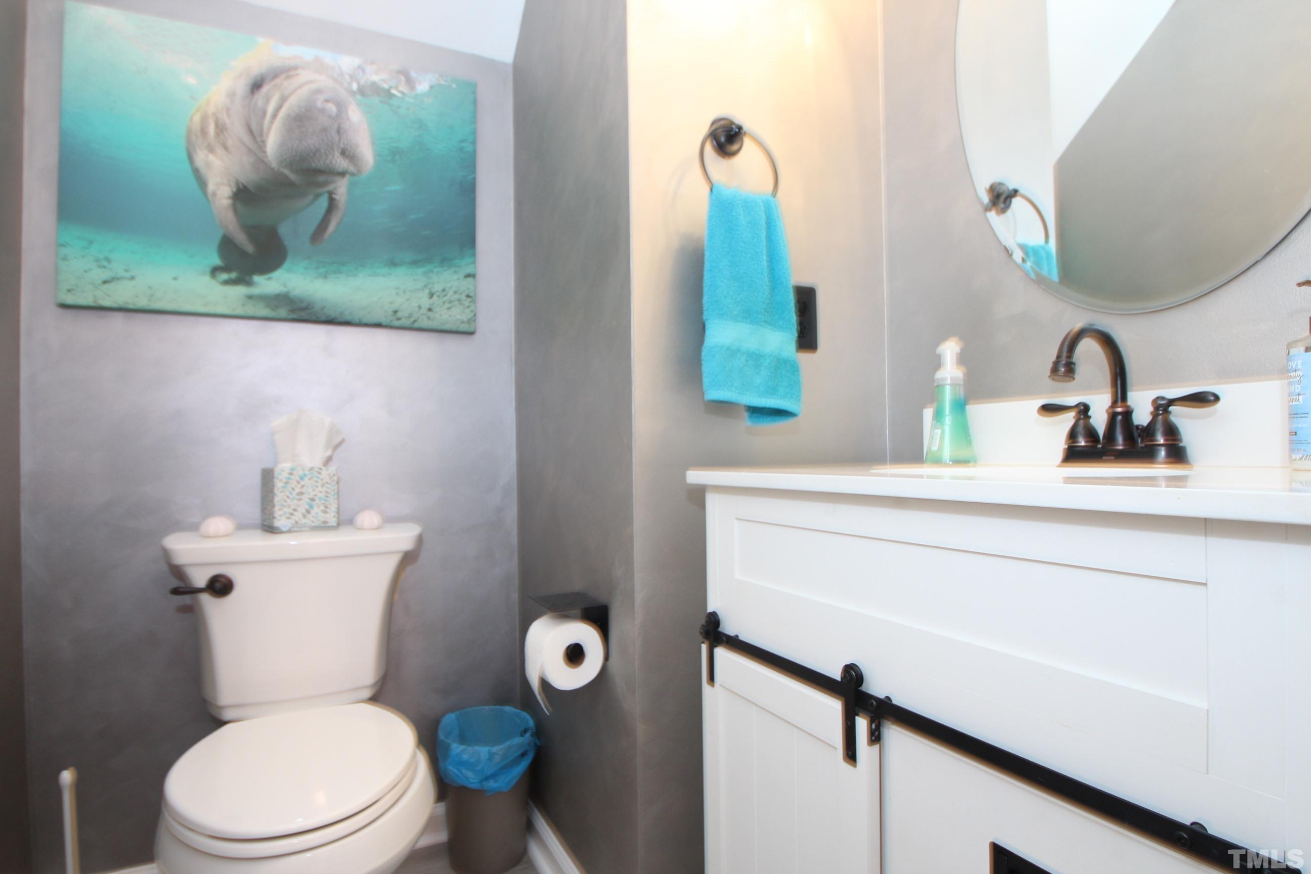 5804 Cameo Glass Way Raleigh, NC 27612 - Photo 21 of 25 a bathroom with a toilet sink and mirror