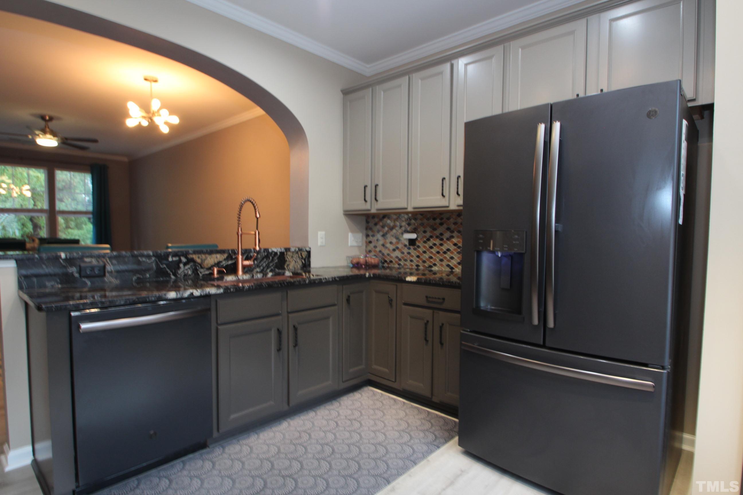 5804 Cameo Glass Way Raleigh, NC 27612 - Photo 4 of 25 a kitchen with stainless steel appliances granite countertop a refrigerator and a sink