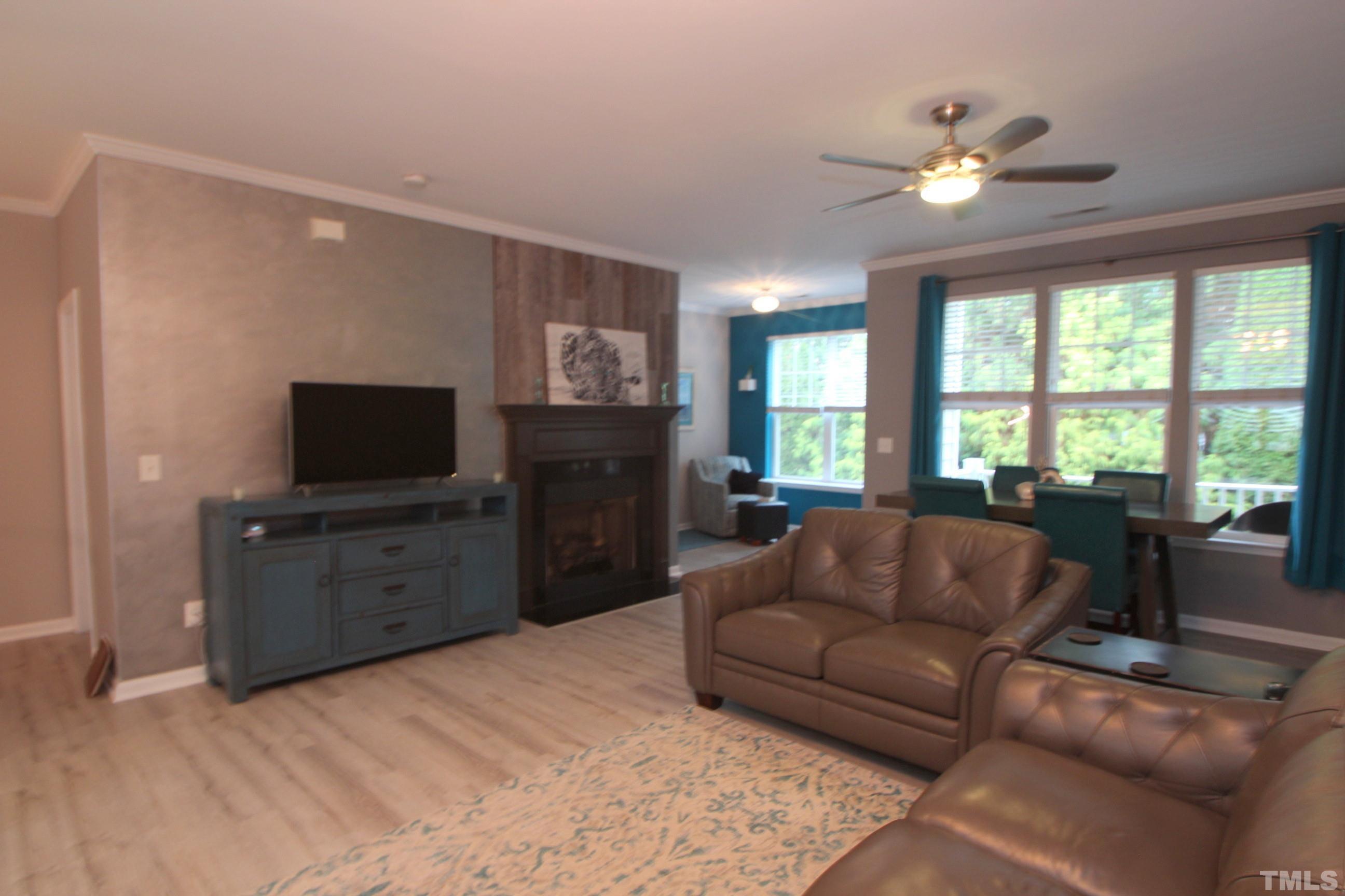 5804 Cameo Glass Way Raleigh, NC 27612 - Photo 5 of 25 a living room with furniture and a flat screen tv
