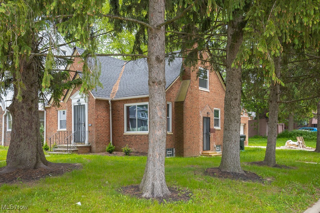 1547 Genesee Road South Euclid, OH 44121 - Photo 35 of 36 View of front facade with brick siding, roof with shingles, and a front lawn