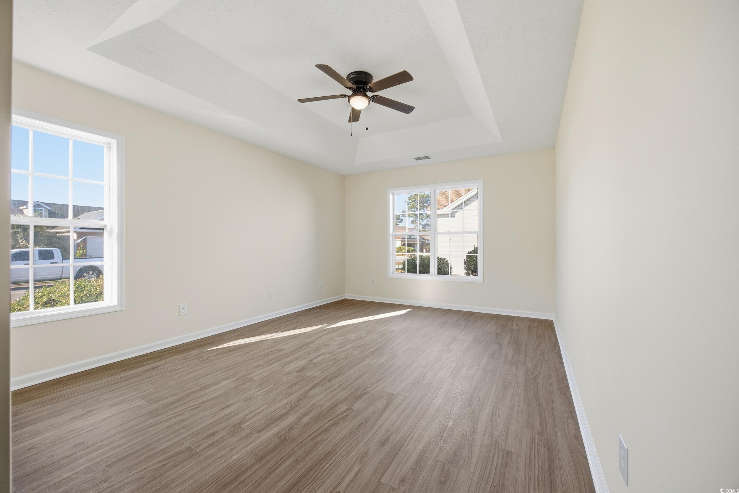 638 Hatteras River Road Myrtle Beach, SC 29588 - Photo 12 of 33 Kitchen featuring stainless steel appliances, hanging light fixtures, brown cabinetry, light stone counters, and a textured ceiling