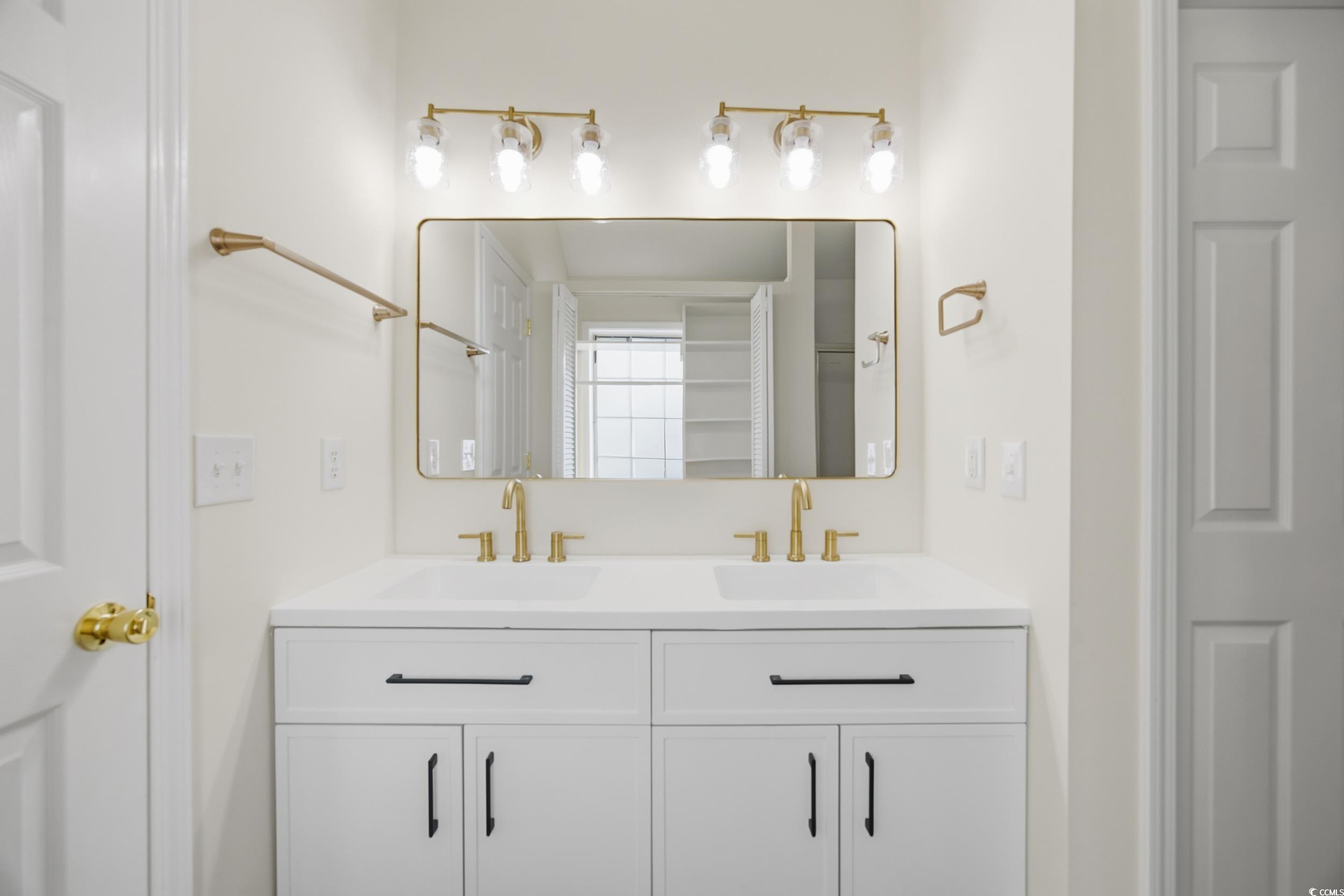 638 Hatteras River Road Myrtle Beach, SC 29588 - Photo 17 of 33 Unfurnished bedroom featuring light wood-type flooring, a raised ceiling, a ceiling fan, and connected bathroom