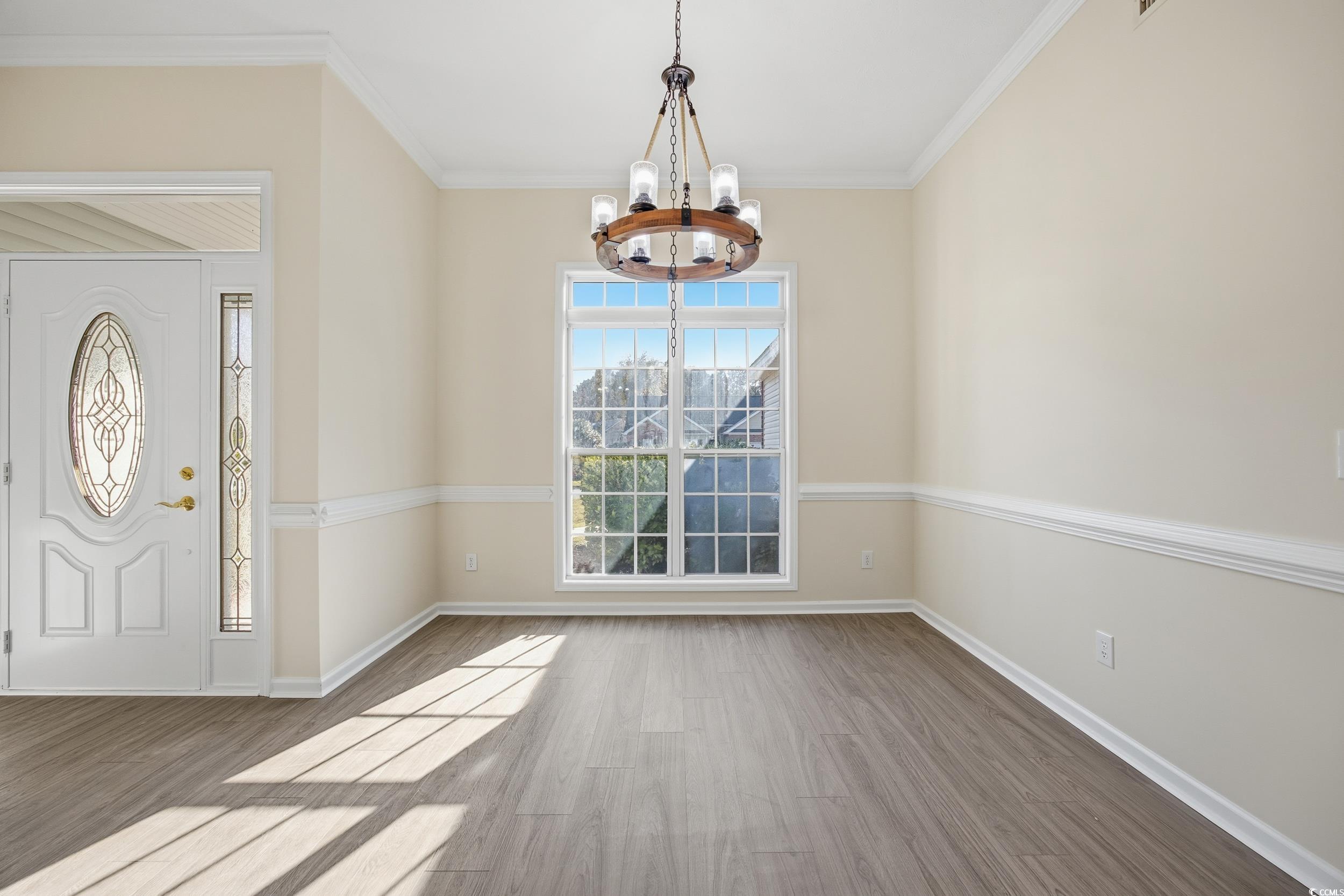 638 Hatteras River Road Myrtle Beach, SC 29588 - Photo 7 of 33 Unfurnished living room featuring a chandelier, light wood-style flooring, and lofted ceiling