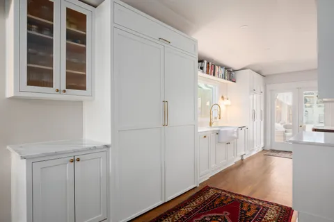 a kitchen with a stove a table and chairs