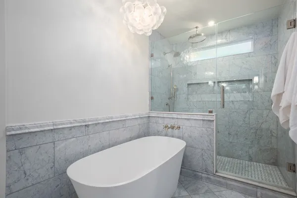 a bathroom with a toilet and a mirror