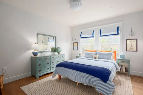 a bedroom with a bed and a dresser in it