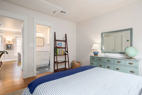 a bathroom with a toilet a bath tub a sink and mirror