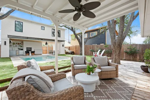 a front view of a house with garden and trees