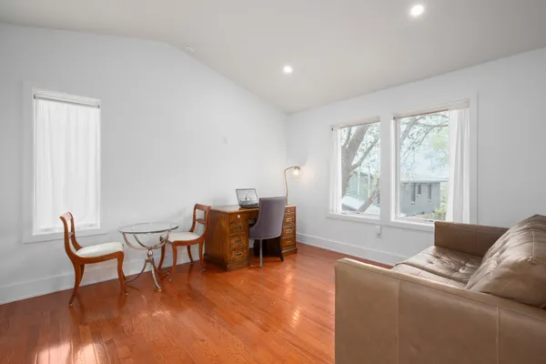 a kitchen with stainless steel appliances white cabinets and wooden floors