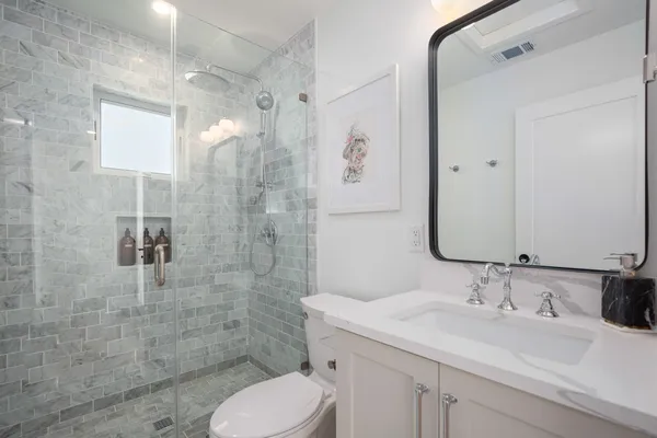 a bedroom with a bed and a mirror