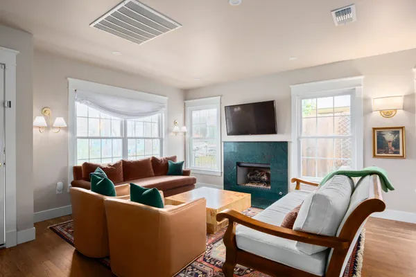 a living room with furniture and a fireplace