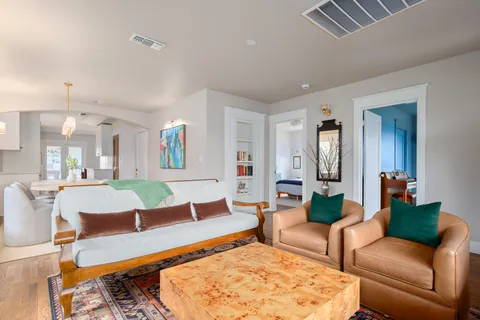 a living room with furniture and wooden floor