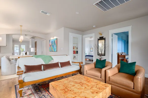 a living room with furniture and wooden floor