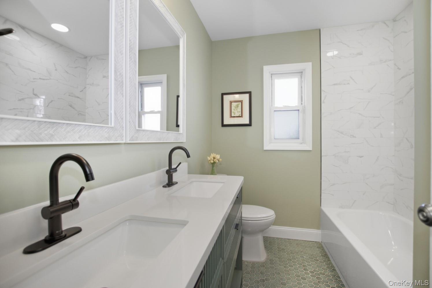 57 Remson Street Valley Stream, NY 11580 - Photo 11 of 27 Full bathroom with double vanity and a combined bath / shower with marble appearance