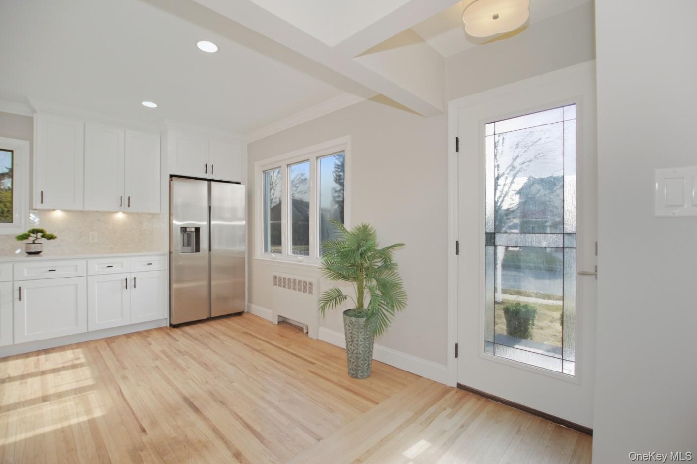 57 Remson Street Valley Stream, NY 11580 - Photo 4 of 27 Eat In Kitchen and Entryway featuring healthy amount of natural light, wood finished floors