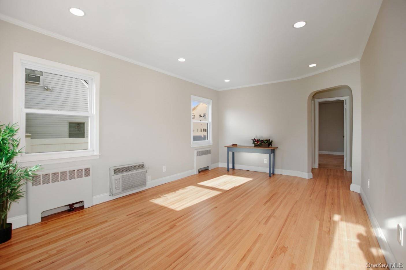57 Remson Street Valley Stream, NY 11580 - Photo 7 of 27 Living room with refinished hardwood floors, crown molding and lots of natural light