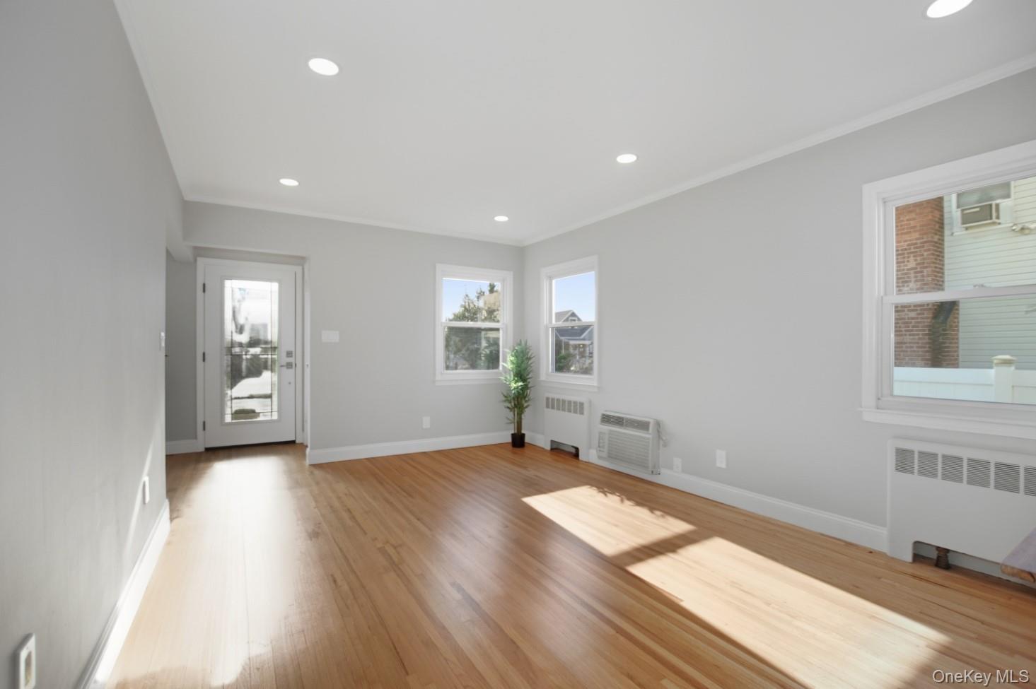 57 Remson Street Valley Stream, NY 11580 - Photo 8 of 27 Living Room with refinished hardwood floors, crown molding and lots of natural light