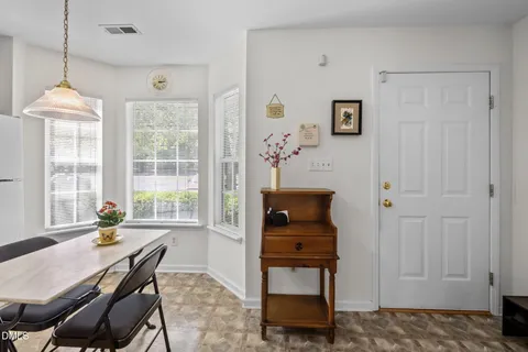 a dining room with furniture and window