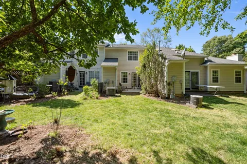 a view of a house with backyard porch and sitting area