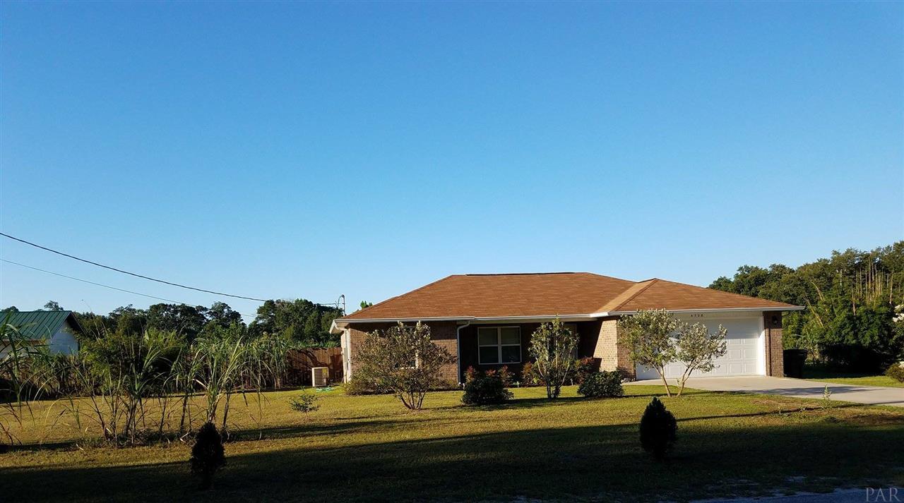 4708 Old Guernsey Road Pace, FL 32571 - Photo 3 of 46 a front view of a house with a yard