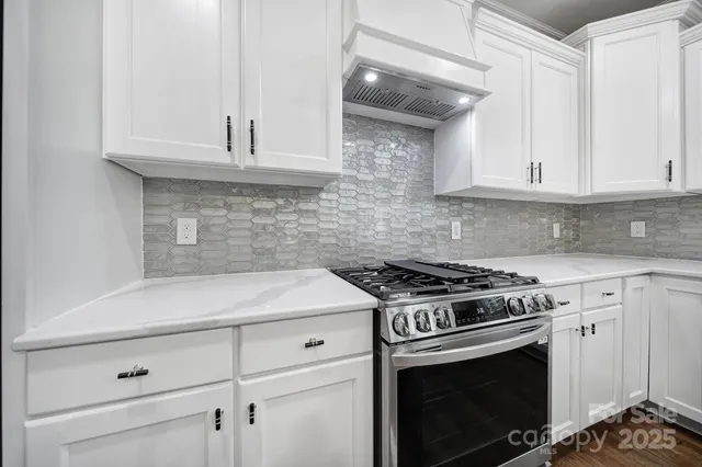 a kitchen with kitchen island a sink stainless steel appliances and cabinets