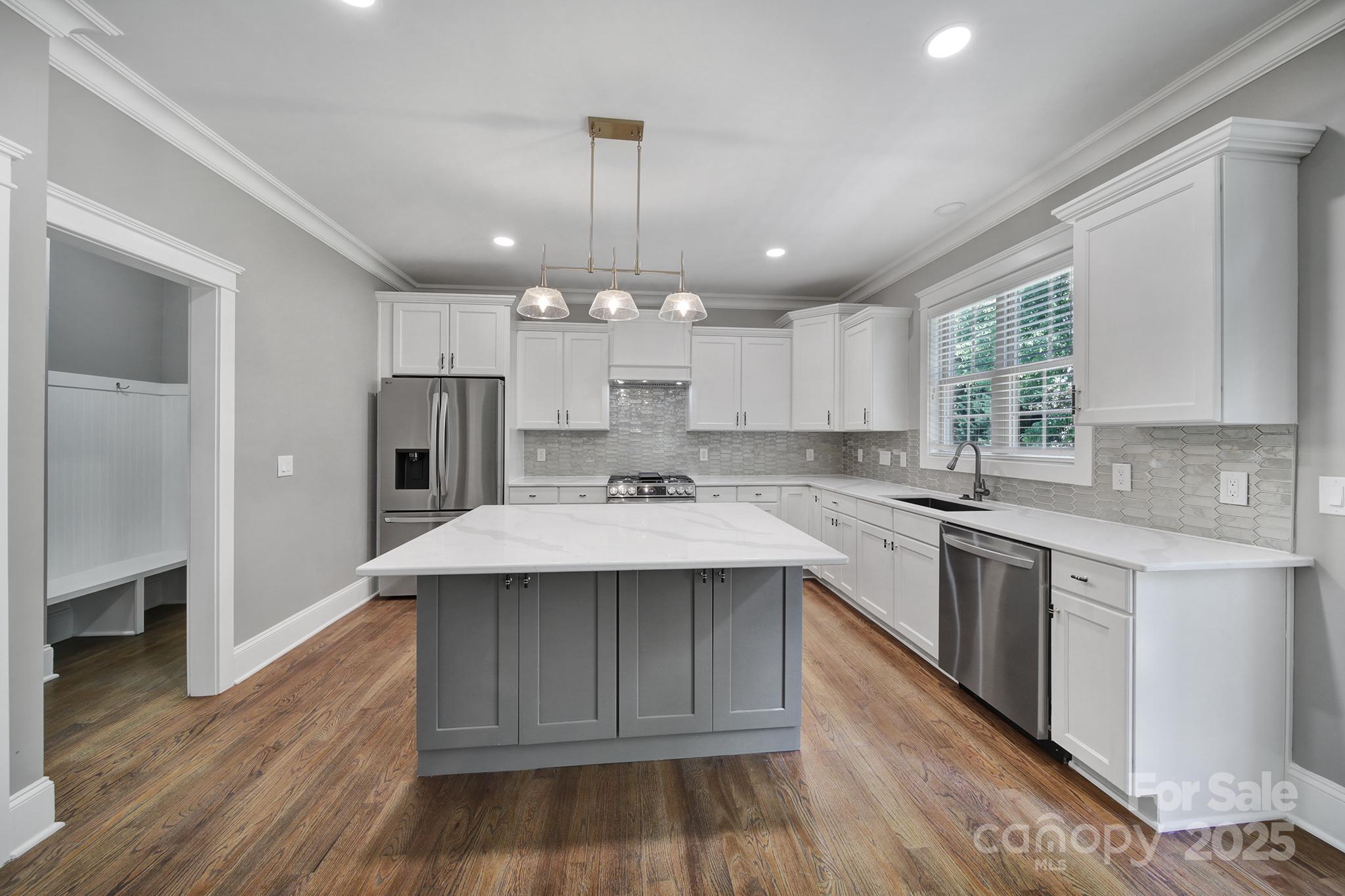 5633 Open Book Lane Charlotte, NC 28270 - Photo 19 of 48 a kitchen with kitchen island a sink stainless steel appliances and cabinets